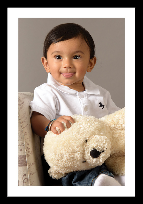 Portrait of a little boy holding a bear
